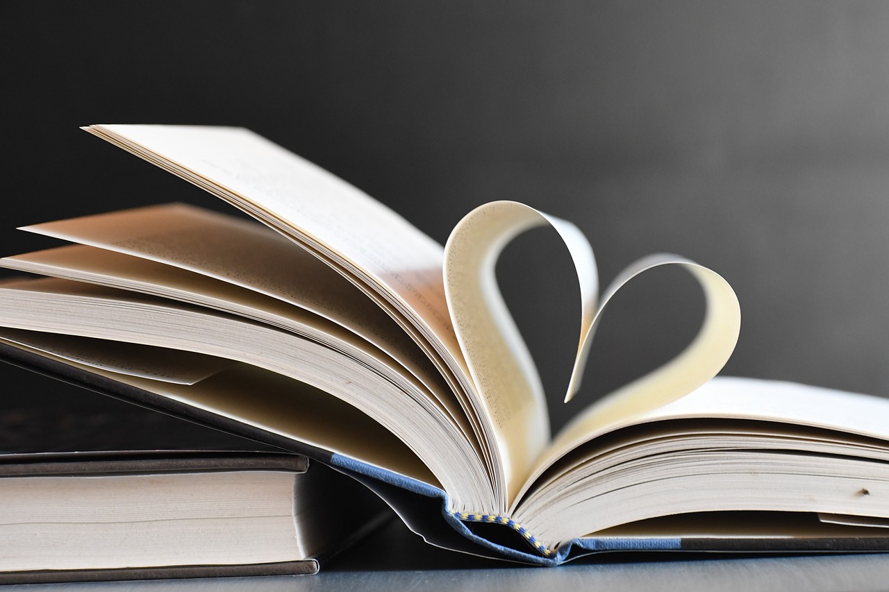 A heart shape created by the middle pages inside of a book.